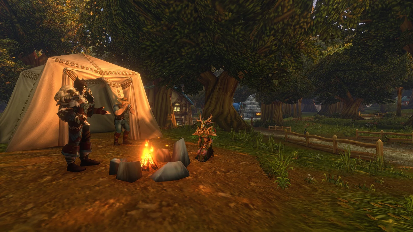 Three adventurers gather beside a canvas tent and a glowing campfire near a woodland village.