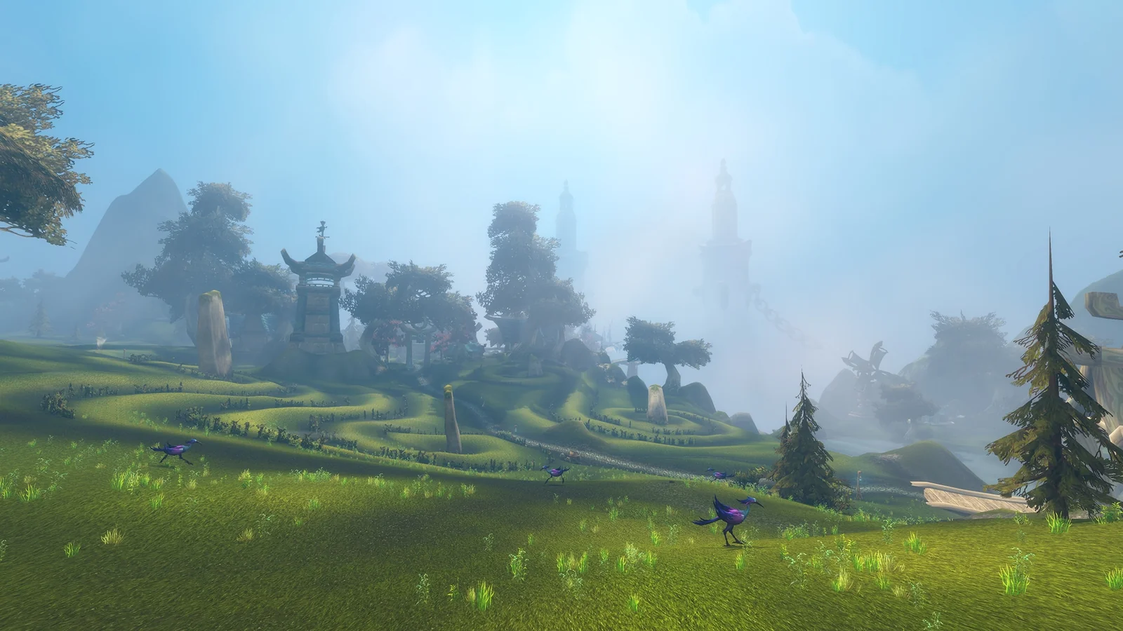 Grassy hills, violet birds and distant towers in the clouds in Blizzard’s Zephras Isle preview.